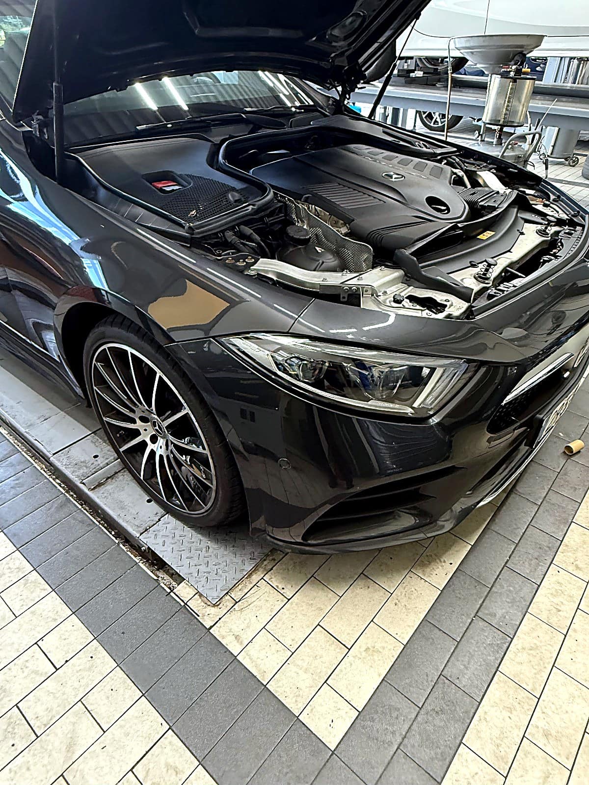 보닛을 열고 리프트 위에 올라온 검은색 벤츠 CLS450 C257